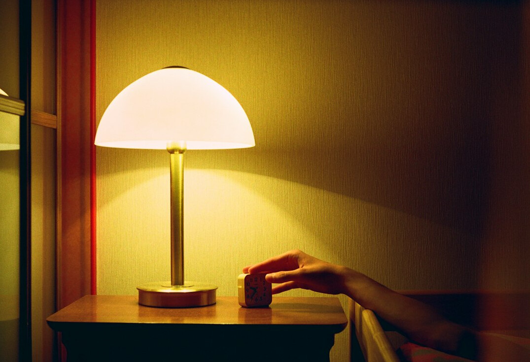 person reading mystery book by lamp